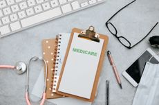 Small clipboard on desk with paper that says Medicare.